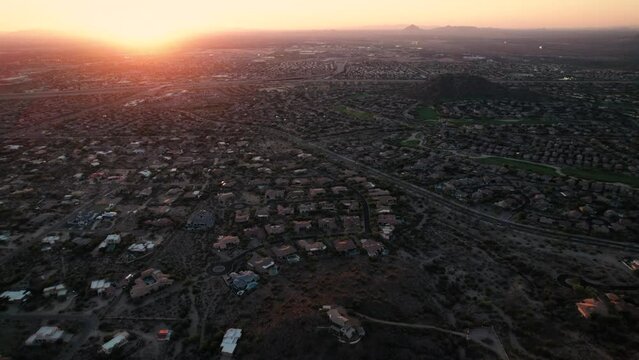 Glowing Sunset Aerial of Arizona Neighborhood Golf Course with Mountain Background