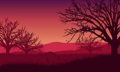 A Mountain view with beautiful tree silhouettes from the outskirts of the village at sunrise