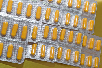 yellow capsules pills pills in a silver blister close-up