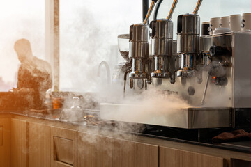 Barista is releasing steam from coffee machine