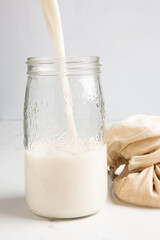 Nut milk being poured into a jar
