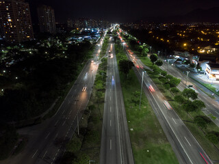 Fototapeta na wymiar Night aerial view of Avenida das Americas in Barra da Tijuca in Rio de Janeiro, Brazil. Long exposure to leave traces in cars and traffic. Drone take
