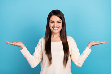 Photo of young girl hold hands pros cons measure solution demonstrate ads isolated over blue color...
