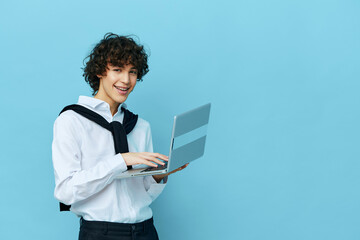 curly guy with laptop internet in a white shirt with a sweater isolated backgrounds