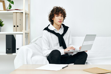 guy on a white sofa in front of a laptop learning Lifestyle technology