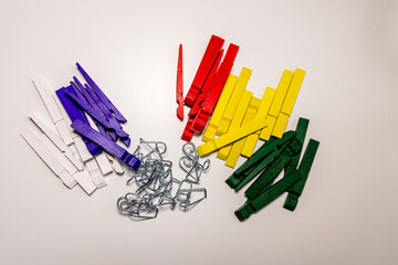 clothespins are disassembled and painted and on the table