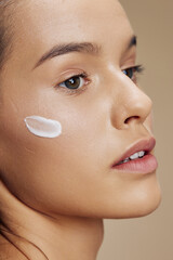 Obraz na płótnie Canvas beautiful woman cream on cheek posing cosmetics to clean skin isolated background