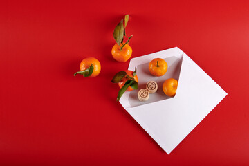 2023 and tangerines in a white envelope on a red background