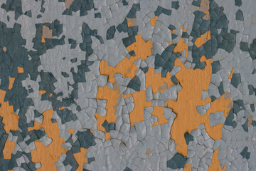 Peeling paint on the wall. Old concrete wall with cracked flaking paint. Weathered rough painted surface with patterns of cracks and peeling. High resolution texture for background and design. Closeup