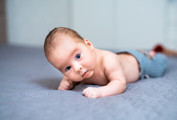 Newborn baby in a hat. Little boy in a blue suit