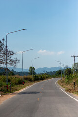 Fototapeta premium empty rural road with light pole and mountain on background vertical frame