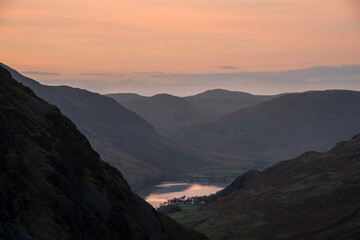 Naklejka na ściany i meble Stunning colorful landscape image of view down Honister Pass to Buttermere from Dale Head in Lake District during Autumn sunset