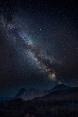 Naklejka na ściany i meble Digital composite image of Milky Way and stunning landscape image of stunning Langdale Pikes looking from Holme Fell in Lake District