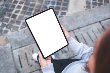 Top view mockup image of a woman holding digital tablet with blank white desktop screen