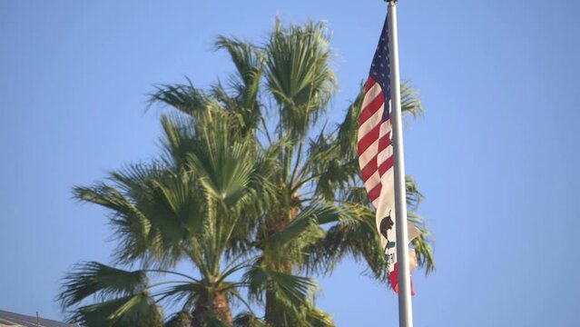 United States flag and california state flag waving in the wind in slow motion 180fps