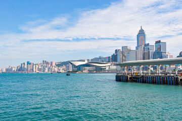 Central Ferry Pier with Hong Kong Skyscraper Background along Victoria Harbor, Hong Kong Island - obrazy, fototapety, plakaty