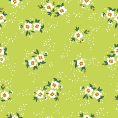 Seamless vintage pattern. White flowers and dots, green leaves on a light green background. vector texture. trendy print for textiles, wallpaper and packaging.