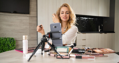 A beautiful young woman blogs about makeup and beauty products. Gorgeous lady removes makeup...