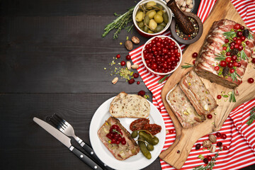 Traditional French terrine covered with bacon on dark wooden background with Christmas decorations