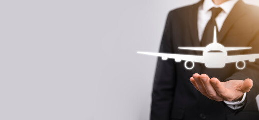 Businessman holding an airplane icon in his hands. Online ticket purchase.Travel.