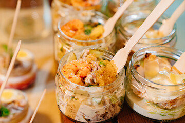 close up. Catering. convenient portioned serving of salads with shrimps in small jars. beautiful original table setting for banquet.