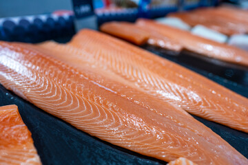 Fresh salmon fillet for sale on display in supermarket - obrazy, fototapety, plakaty