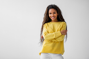 Portrait natural of curly brunette african american dark skinned woman in yellow blouse smiling...