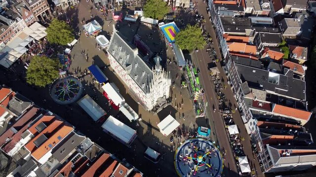 Aerial turn over fair at downtown Gouda is town in west of Netherlands between Rotterdam and Utrecht in province of South Holland and is famous for its cheese stroopwafels grachten and its city hall