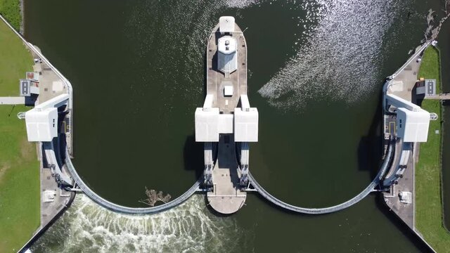 Aerial top down view of modern water channel controller controlled at both sides by a gate or lock these gates commonly control levels and flow rates in rivers and canals 4k high resolution footage