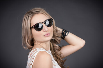 portrait of a young woman with glasses in a photo studio