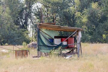 Oil and fuel barrels under shed on a farm