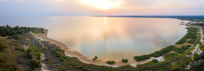 Aerial drone view of a lake bay and sunset