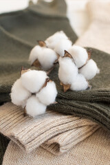 Concept of slow fashion. Two basic sweaters made of natural organic materials are on white wooden background.