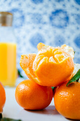 Bottle of tangerine juice and fresh fruit on marble