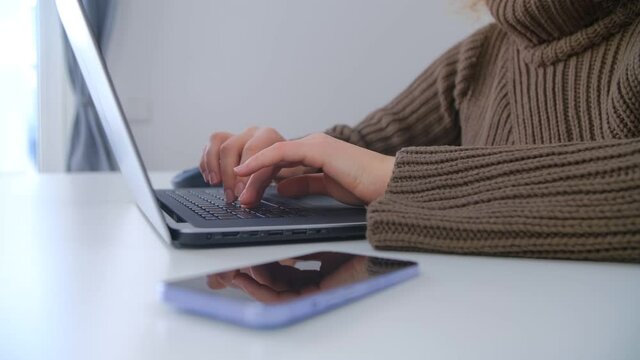 Freelancer woman typing on laptop keyboard. Professional free lance writer working on modern notebook pc. Female studying online from home during lockdown in 4k stock footage
