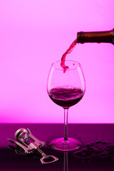 glass goblet of red wine on a lila background
