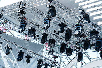 Concert stage lighting equipment. Metal structure with a canopy and various spotlights. Bottom up view. Selective focus