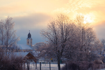 Rural hungarian village covered in snow at sunset
