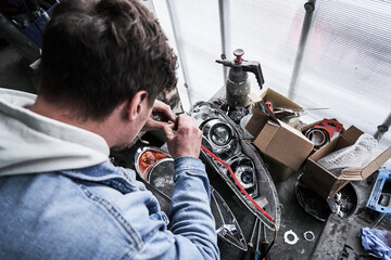 Car service worker repairs restores car