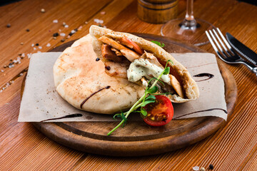 Pita with roasted chicken and vegetables, served with a delicious sauce
