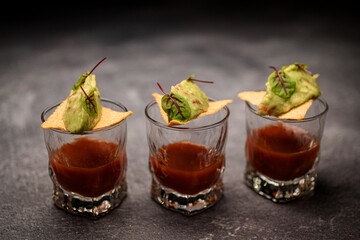 glasses of tomato drink garnished with crispy nachos with delicious sauce