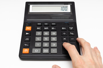 the finger of the hand presses the keys of the old calculator