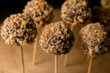 Close-up view of chocolate candy pops on wooden sticks