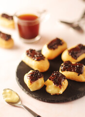 Traditional French dessert - eclairs with a cup of coffee