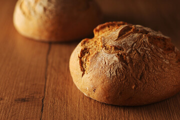 Two loaves of rye bread in low key	