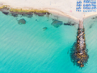 top view of the turquoise sea, sandy beach and pier