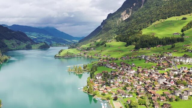 Lungern, Switzerland. Aerial view of the mountain valley and village. The lake among the mountains. Landscape from a drone. 