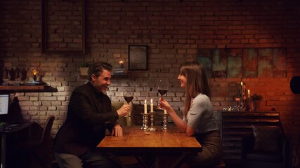 Stay at home and order food online - Couple having romantic dinner in home quarantine, eating from takeaway box and drinking red wine.