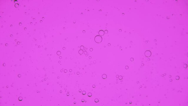 Oil bubbles in slow motion, gradient lighting, macro
