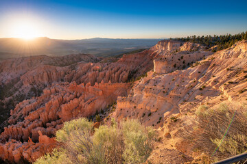 Aerial view of Bryce Canyon at summer sunrise. Overlook of orange colorful hoodoos red rock formations in Bryce Canyon National Park, Utah - USA.